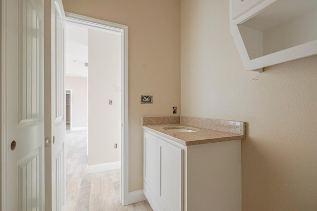 2201 S County Rd 1059, Midland, TX 79706 - bathroom featuring vanity, wood finished floors, and baseboards