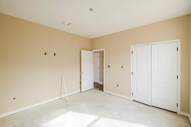 2201 S County Rd 1059, Midland, TX 79706 - unfurnished bedroom featuring unfinished concrete floors, baseboards, and a closet