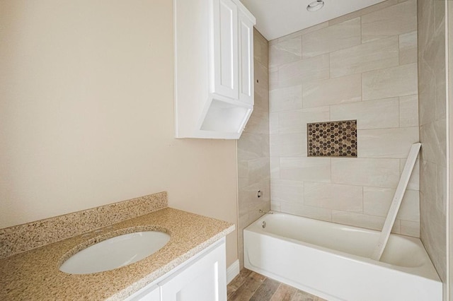2201 S County Rd 1059, Midland, TX 79706 - full bathroom with vanity, wood finished floors, and washtub / shower combination