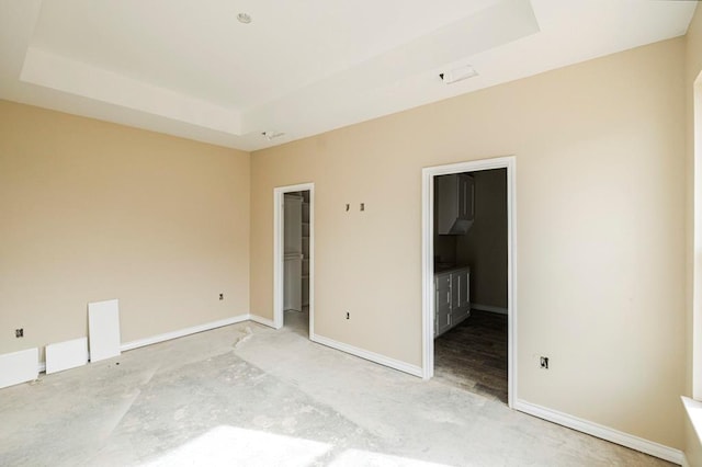 2201 S County Rd 1059, Midland, TX 79706 - unfurnished bedroom featuring a spacious closet, a raised ceiling, and baseboards