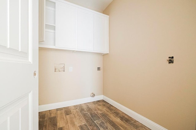 2201 S County Rd 1059, Midland, TX 79706 - laundry room with cabinet space, dark wood-type flooring, and baseboards