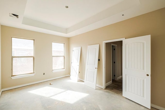 2201 S County Rd 1059, Midland, TX 79706 - unfurnished bedroom with a raised ceiling and baseboards