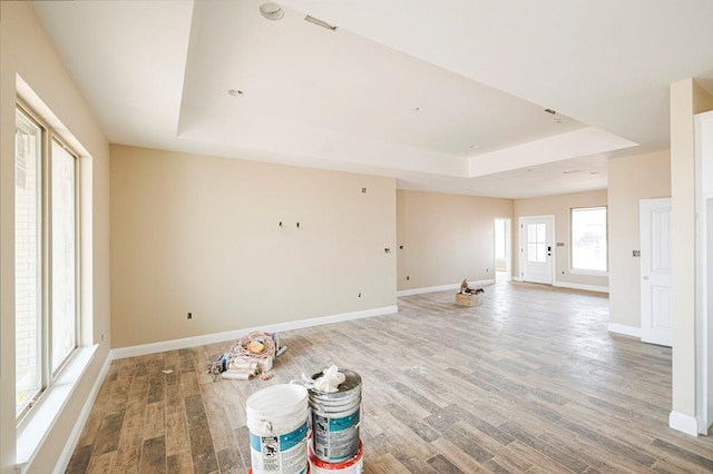 2201 S County Rd 1059, Midland, TX 79706 - unfurnished room with a tray ceiling, baseboards, and light wood-type flooring