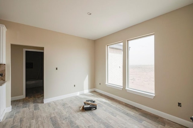 2201 S County Rd 1059, Midland, TX 79706 - unfurnished room featuring light wood-style flooring and baseboards