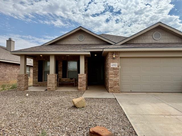 6712 Spur Dr, Midland, TX 79705 - view of front of property featuring a porch, driveway, a garage, a shingled roof, and brick siding