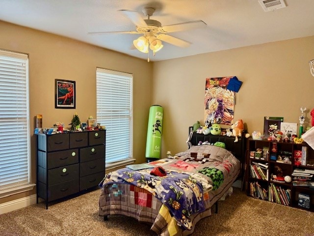 6712 Spur Dr, Midland, TX 79705 - carpeted bedroom featuring multiple windows and ceiling fan