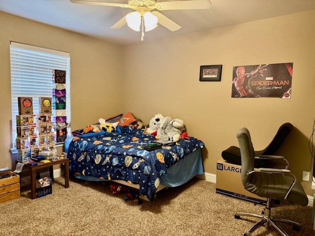 6712 Spur Dr, Midland, TX 79705 - carpeted bedroom with a ceiling fan