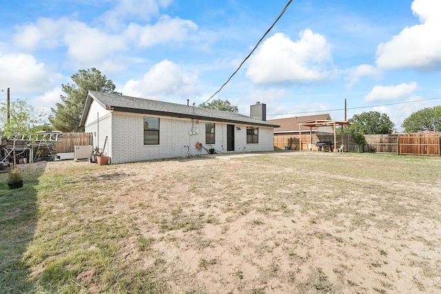 400 Player Ct, Midland, TX 79705 - rear view of house featuring brick siding, a chimney, and a fenced backyard