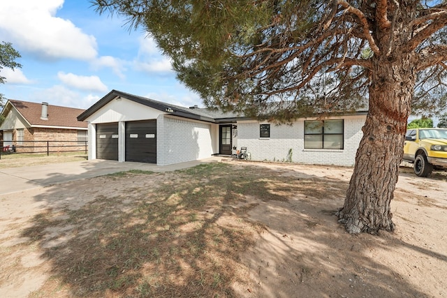 400 Player Ct, Midland, TX 79705 - view of front of property with brick siding, a garage, and concrete driveway