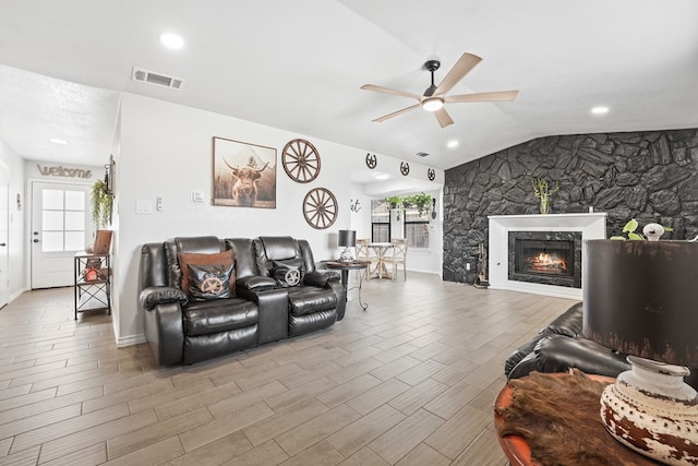 400 Player Ct, Midland, TX 79705 - living area featuring ceiling fan, vaulted ceiling, a warm lit fireplace, wood finished floors, and recessed lighting