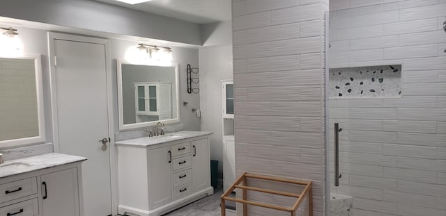 bathroom featuring vanity and a tile shower