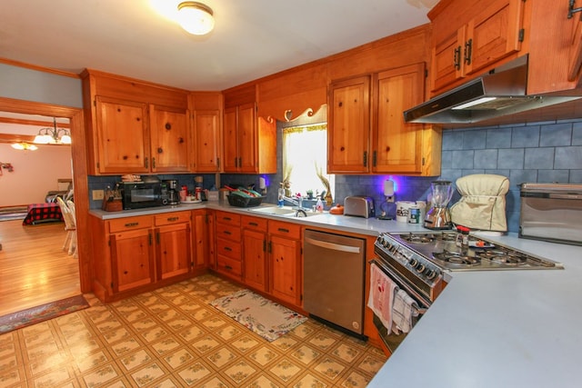 4610 Wasson Rd, Big Spring, TX 79720 - kitchen with light countertops, light floors, stainless steel dishwasher, under cabinet range hood, and brown cabinets