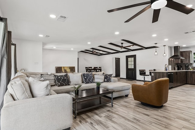 living room featuring light wood-type flooring and sink