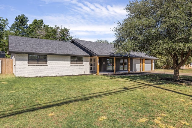 ranch-style house featuring a front yard and a garage