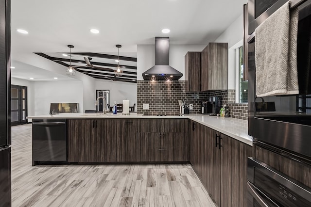 kitchen with beamed ceiling, wall chimney exhaust hood, pendant lighting, and light hardwood / wood-style flooring