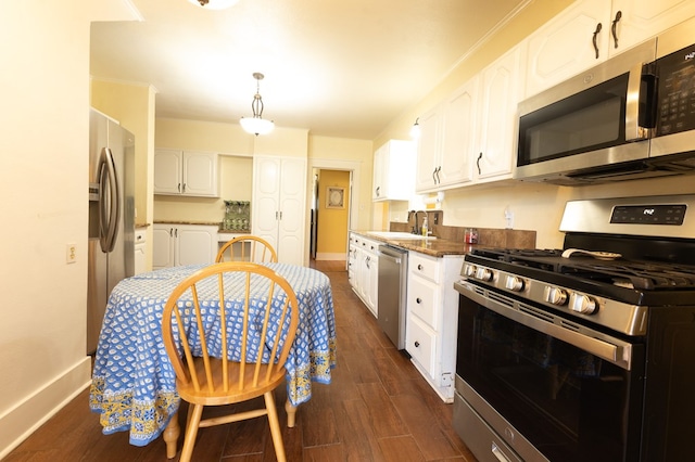 kitchen with white cabinets, appliances with stainless steel finishes, dark hardwood / wood-style flooring, and sink