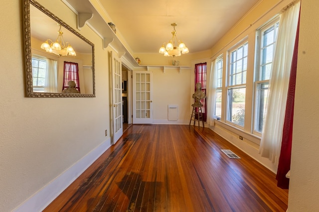 interior space with a chandelier and hardwood / wood-style flooring