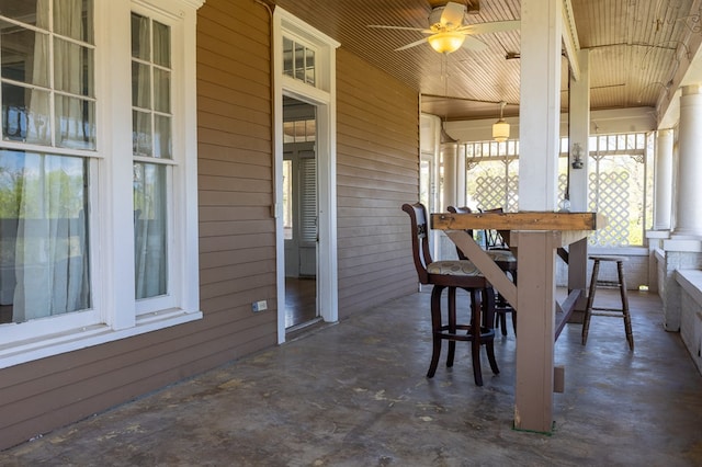 dining area with ceiling fan, wood walls, and wood ceiling