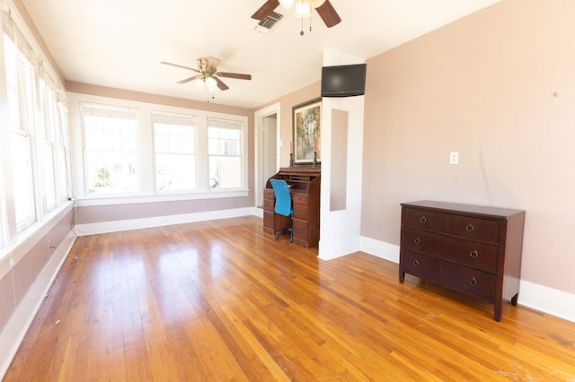 unfurnished living room with ceiling fan and light hardwood / wood-style flooring