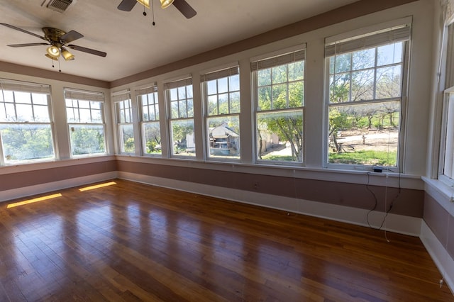 unfurnished sunroom with ceiling fan and plenty of natural light