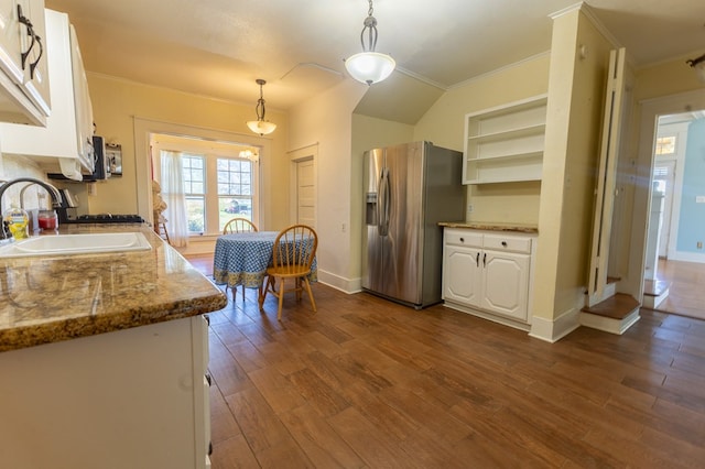 kitchen featuring white cabinets, stainless steel fridge, and pendant lighting