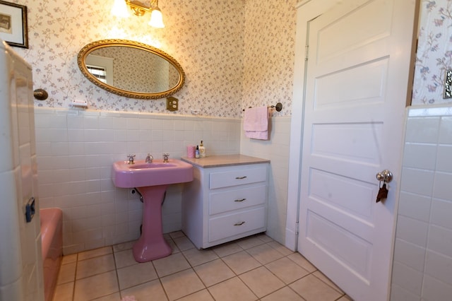 bathroom with tile patterned floors and tile walls