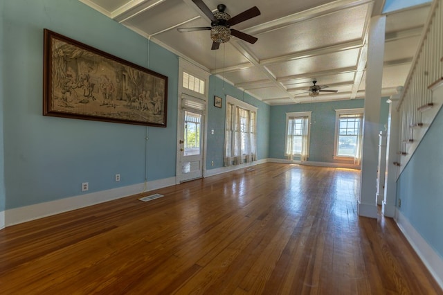 unfurnished living room featuring a wealth of natural light, ceiling fan, coffered ceiling, and hardwood / wood-style flooring