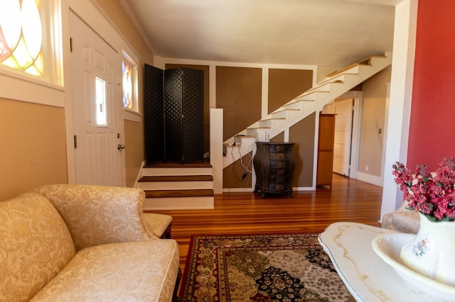 living room featuring dark hardwood / wood-style floors and crown molding