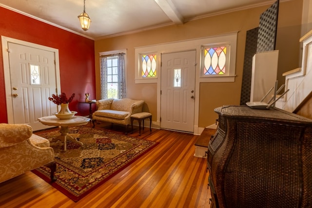 foyer with beamed ceiling, hardwood / wood-style flooring, and crown molding