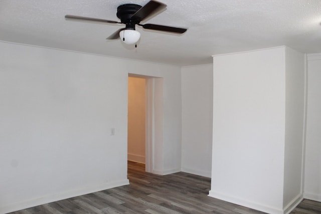 unfurnished room featuring a textured ceiling, dark wood-type flooring, and ceiling fan