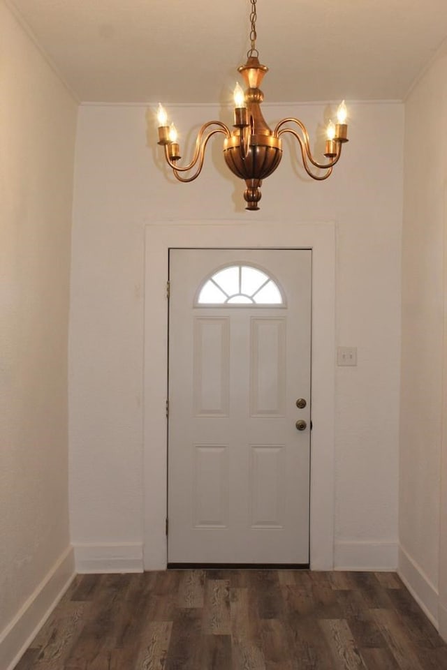 foyer entrance with a notable chandelier and dark hardwood / wood-style flooring