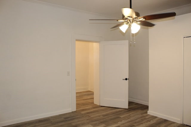 unfurnished room featuring crown molding, dark wood-type flooring, and ceiling fan