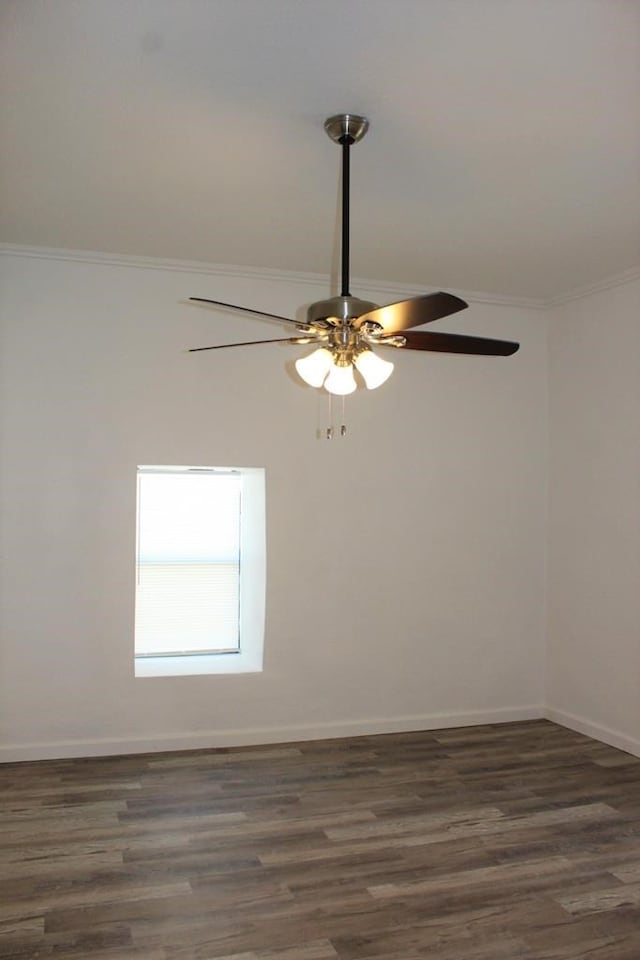 unfurnished room with crown molding, ceiling fan, and dark hardwood / wood-style flooring