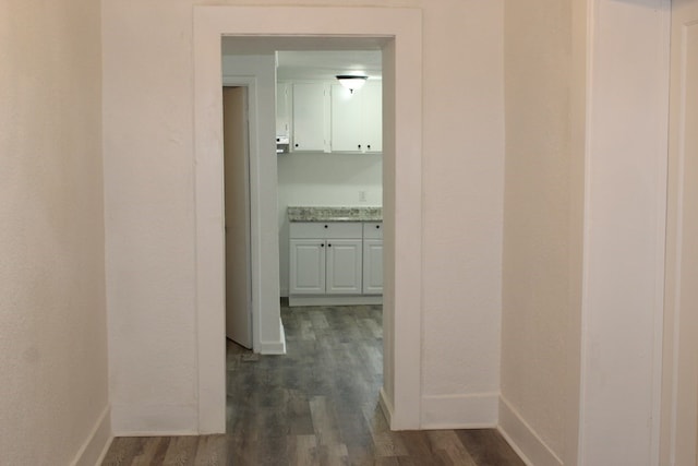 corridor with dark hardwood / wood-style floors