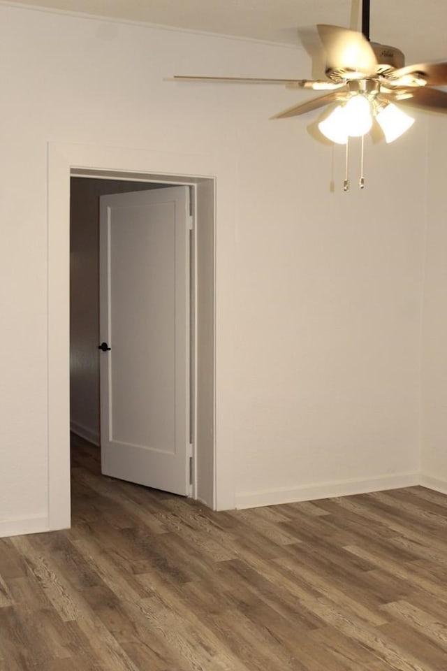 unfurnished room featuring ceiling fan and dark hardwood / wood-style flooring