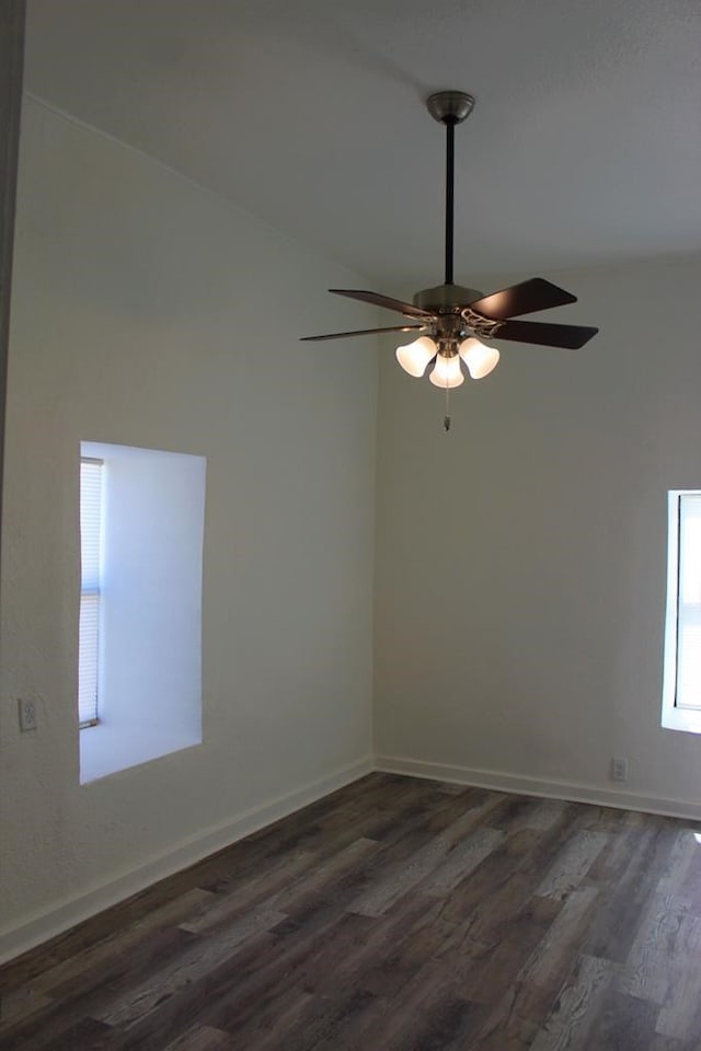 unfurnished room featuring lofted ceiling, dark hardwood / wood-style floors, and ceiling fan