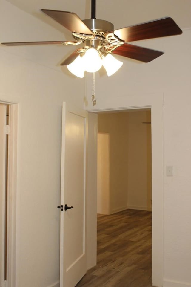 interior space featuring ceiling fan and dark hardwood / wood-style floors