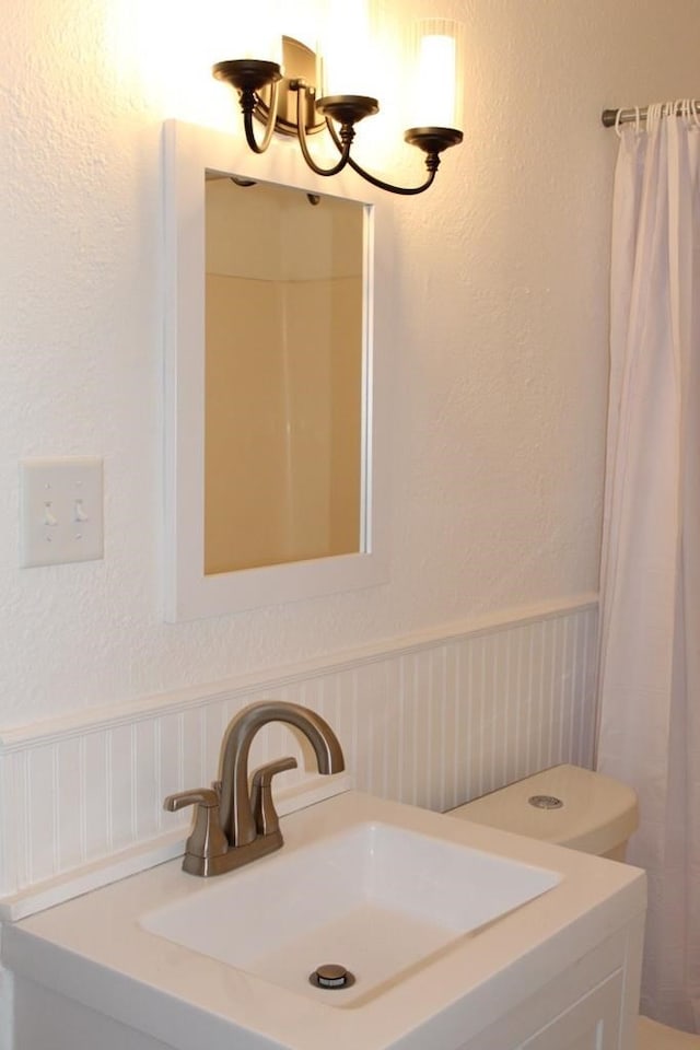 bathroom featuring vanity and curtained shower