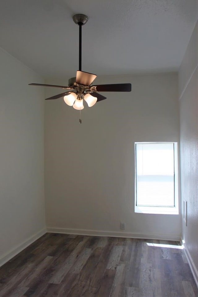 empty room featuring dark wood-type flooring and ceiling fan