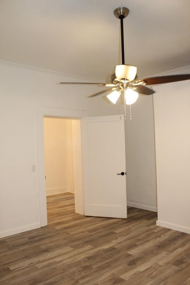 unfurnished room with ceiling fan, ornamental molding, and dark hardwood / wood-style flooring