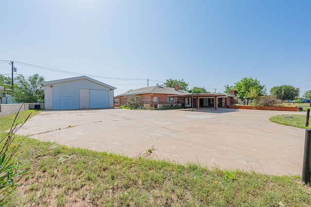 single story home with an outdoor structure and a garage