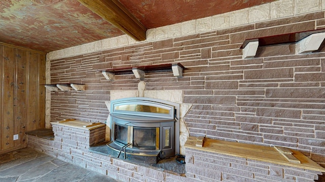 room details featuring beam ceiling and wood walls