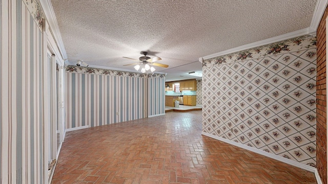 unfurnished room featuring crown molding and a textured ceiling