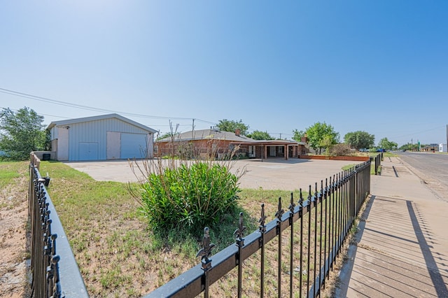 ranch-style home with a garage, a front lawn, and an outdoor structure