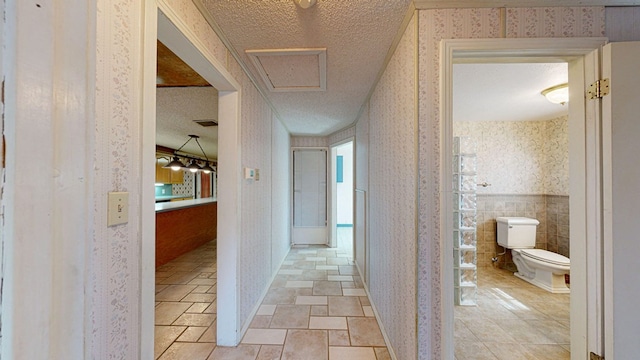 hall featuring a textured ceiling