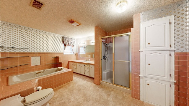 full bathroom featuring plus walk in shower, a textured ceiling, and tile walls