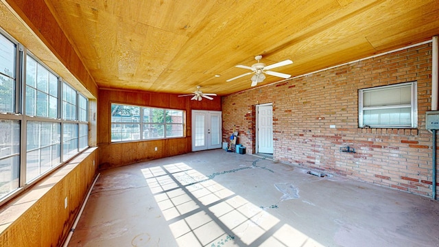 unfurnished sunroom with ceiling fan and wood ceiling