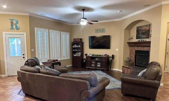 3113 San Pedro Dr, Odessa, TX 79765 - living room with a ceiling fan, baseboards, a fireplace, crown molding, and recessed lighting