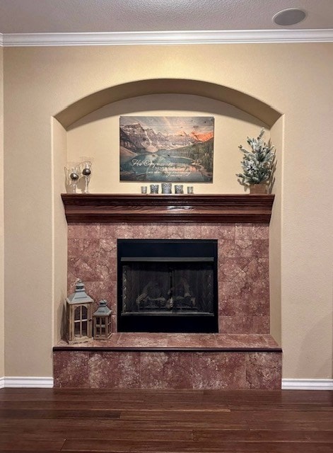 3113 San Pedro Dr, Odessa, TX 79765 - detailed view of wood finished floors, baseboards, ornamental molding, and a tiled fireplace