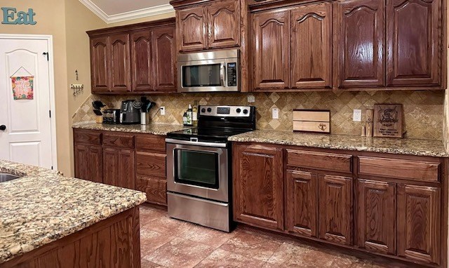 3113 San Pedro Dr, Odessa, TX 79765 - kitchen with stainless steel appliances, backsplash, crown molding, and light stone counters